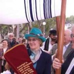 women woman carrying sefer torah